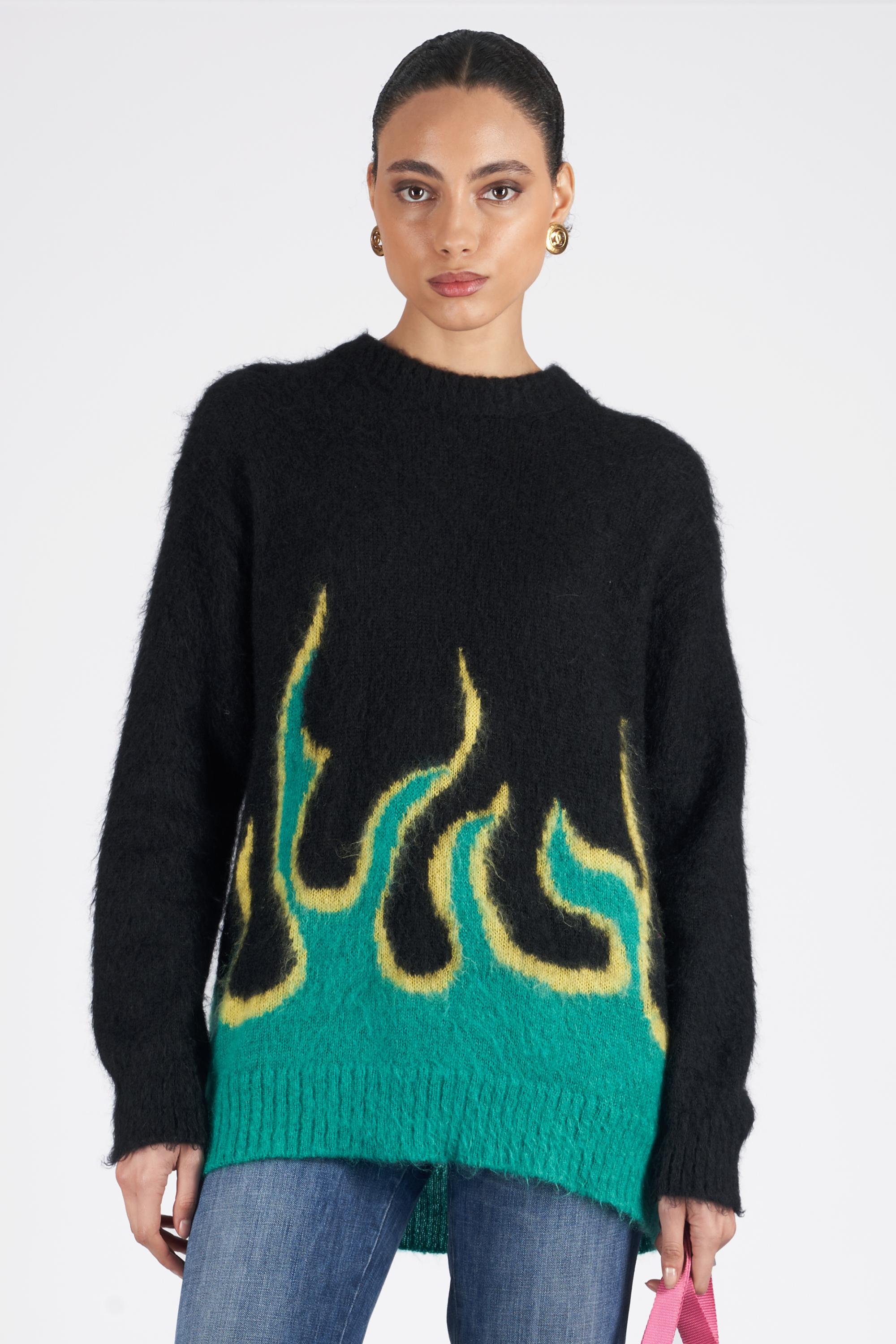 We are excited to present this runway Prada 2018 black knitted oversized jumper. Features green and yellow flame on the hem. In excellent vintage condition. Print as seen on the 2018 runway and worn by Kaia Gerber. Authenticity guaranteed.

Label