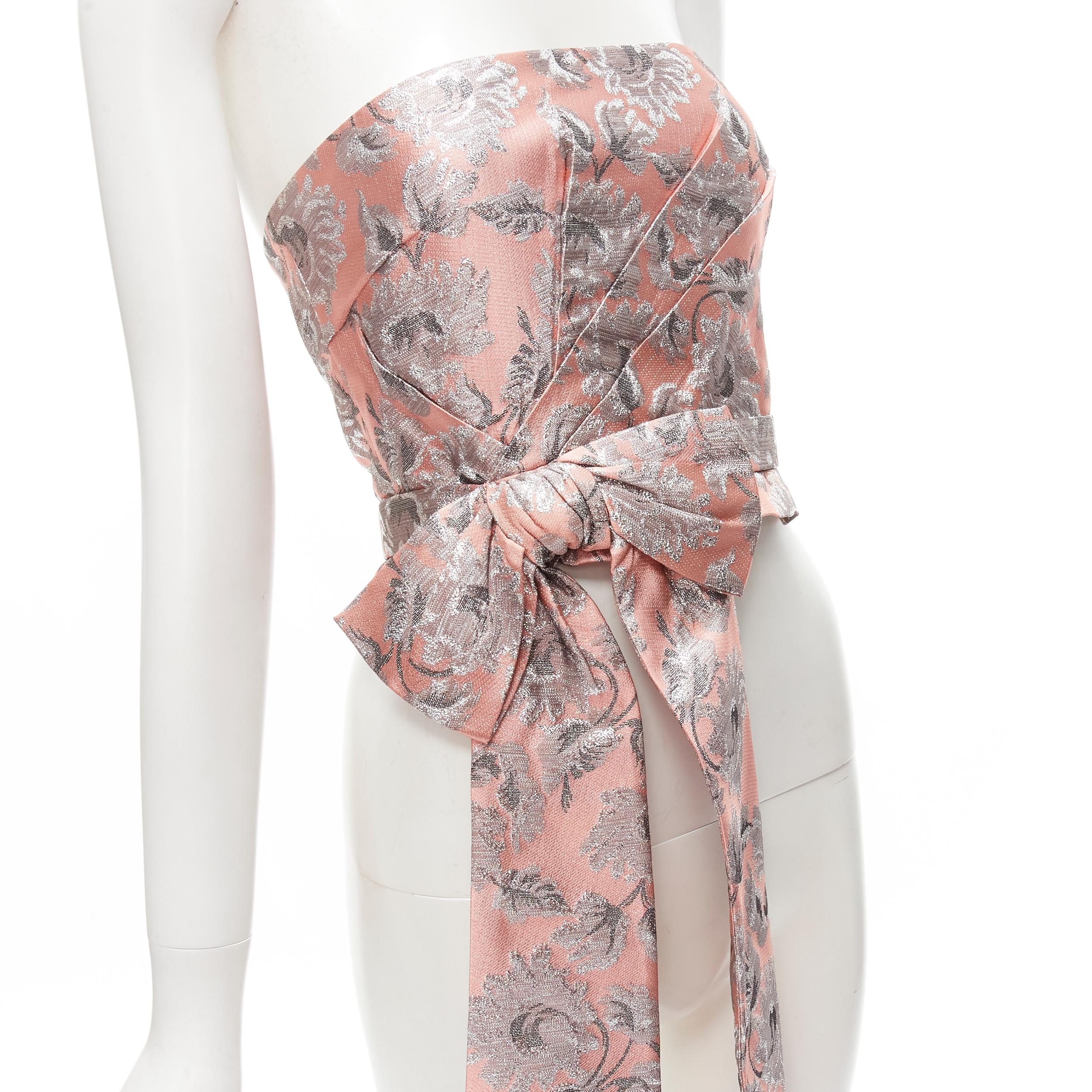 PRADA 2018 metallic pink silver floral brocade bow bustier top S
Brand: Prada
Designer: Miuccia Prada
Collection: 2018 
Material: Feels like polyester
Color: Pink
Pattern: Floral
Closure: Zip
Extra Detail: Zip back closure with hook eye grosgrain