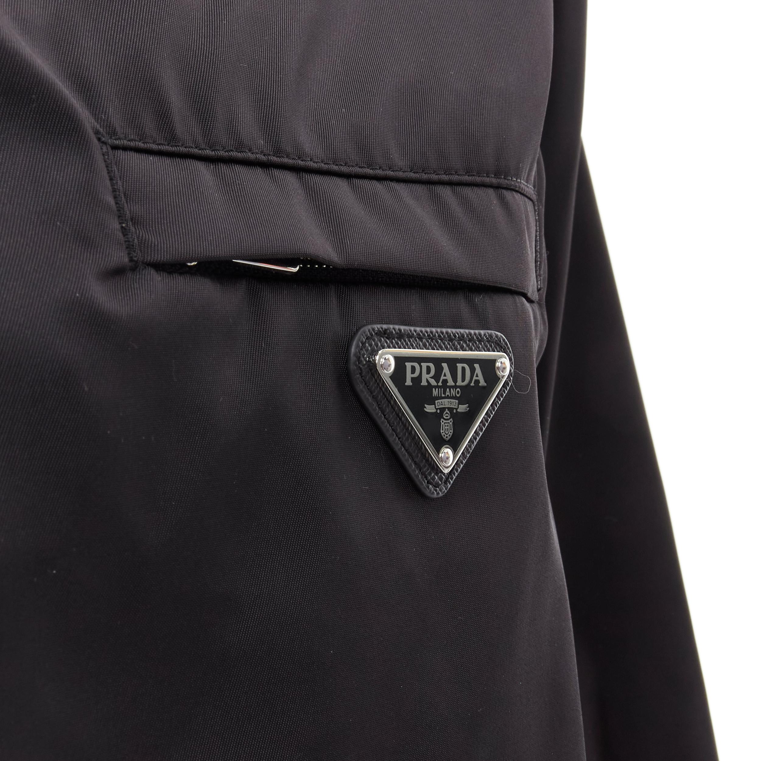 PRADA 2020 Re-Nylon black boat neck triangle logo seal popover sweater shell IT50 L 
Reference: MELK/A00136 
Brand: Prada 
Designer: Raf Simons 
Collection: 2020 
Material: Nylon 
Color: Black 
Pattern: Solid 
Extra Detail: Black Re-Nylon. Logo seal