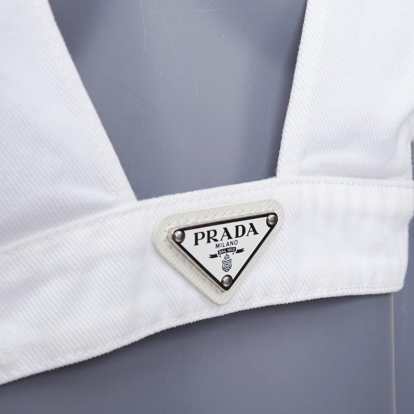 PRADA 2022 white distressed denim triangle logo plunge bralette crop top IT42 M
Reference: TGAS/E00941
Brand: Prada
Designer: Miuccia Prada
Collection: 2022
Material: Denim
Color: White, Silver
Pattern: Solid
Closure: Hook & Bar
Lining: White