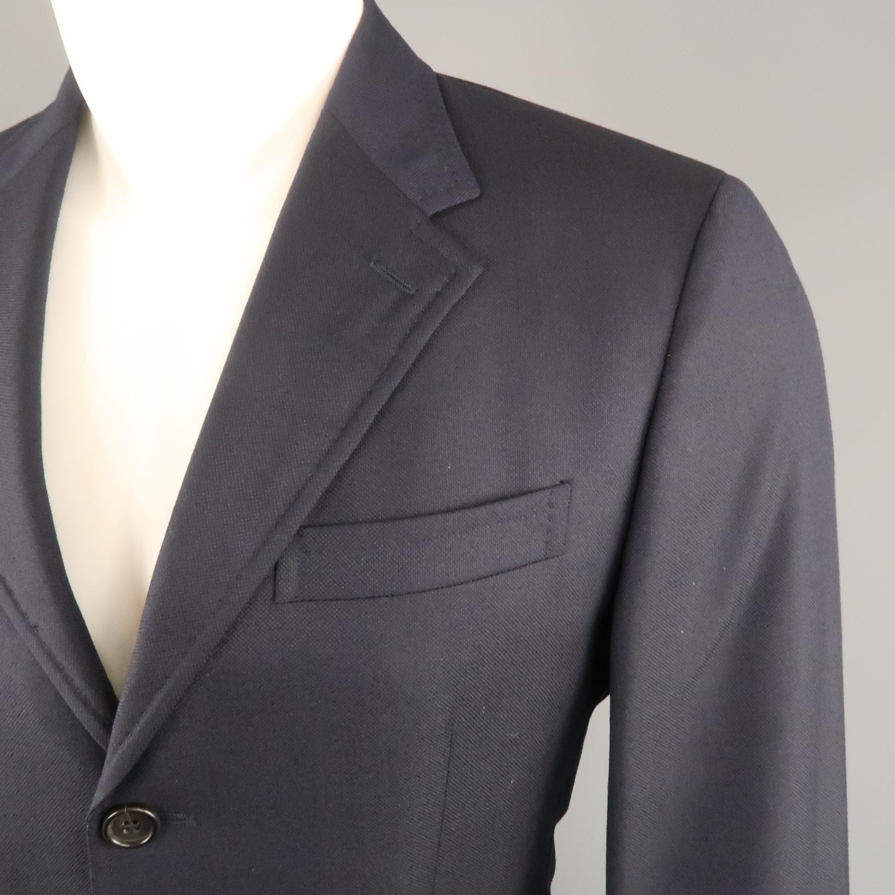 PRADA sport coat comes in navy woven textured wool with a notch lapel, single breasted,  three button front, and flap pockets. Made in Italy.
 
Very Good Pre-Owned Condition.
Marked: IT 48
 
Measurements:
 
Shoulder: 17 in.
Chest: 40 in.
Sleeve: 25