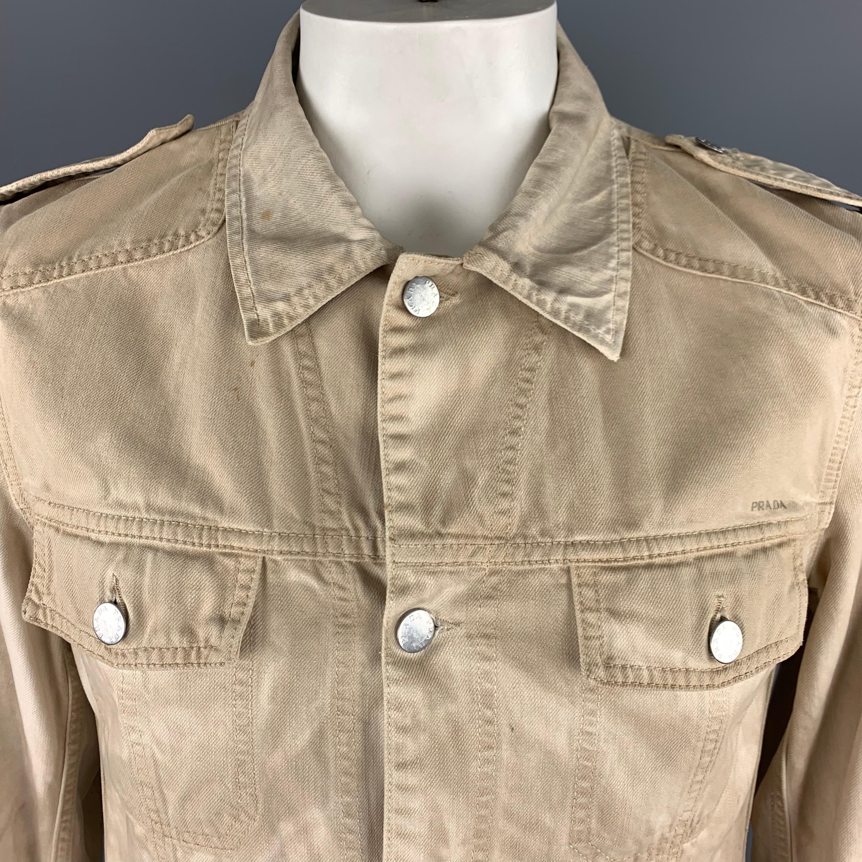 PRADA Dyed Trucker Jacket comes in khaki tones in a cotton material, with epaulettes, patch pockets, buttoned cuffs and front closure. Intentional distressed effect throughout. Made in Italy.
 
Excellent  Pre-Owned Condition.
Marked: IT 52
