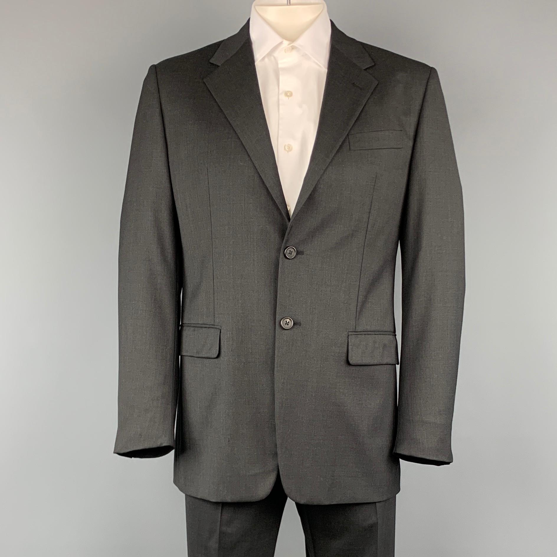 PRADA suit comes in a charcoal wool and includes a single breasted, two button sport coat with a notch lapel and matching front trousers. Made in Italy
 
Excellent Pre-Owned Condition.
Marked: 52 R
 
Measurements:
 
-Jacket
Shoulder: 19.5 in.
Chest: