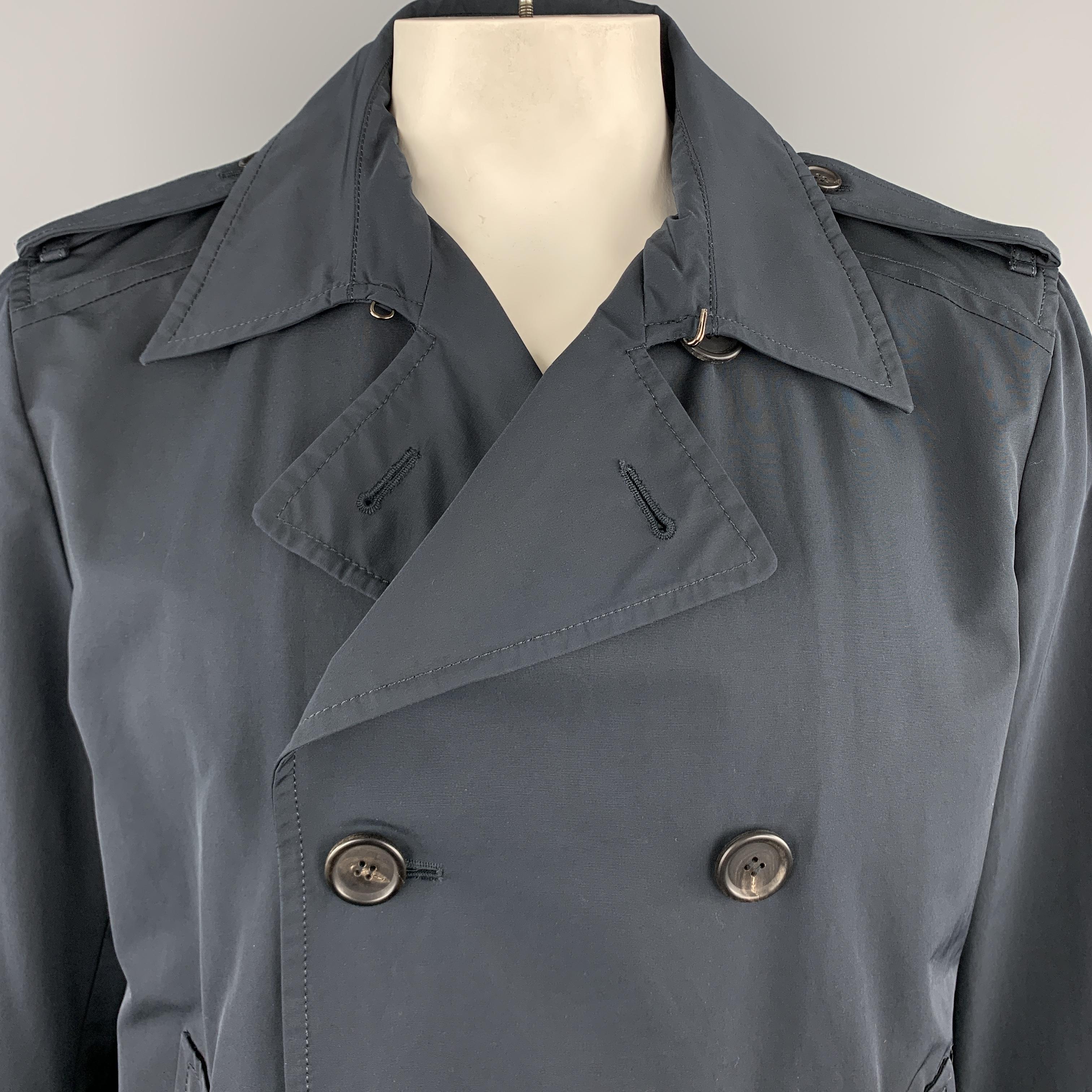 PRADA pea coat comes in muted navy blue cotton blend fabric with a double breasted button front, slanted pockets, epaulets, and half liner. Made in Italy.

Very Good Pre-Owned Condition.
Marked: IT 56

Measurements:

Shoulder: 17 in.
Chest: 48
