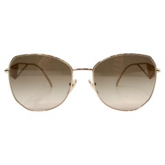 Prada 57Y Goldfarbene Aviator-Sonnenbrille mit Metallrahmen und Logo