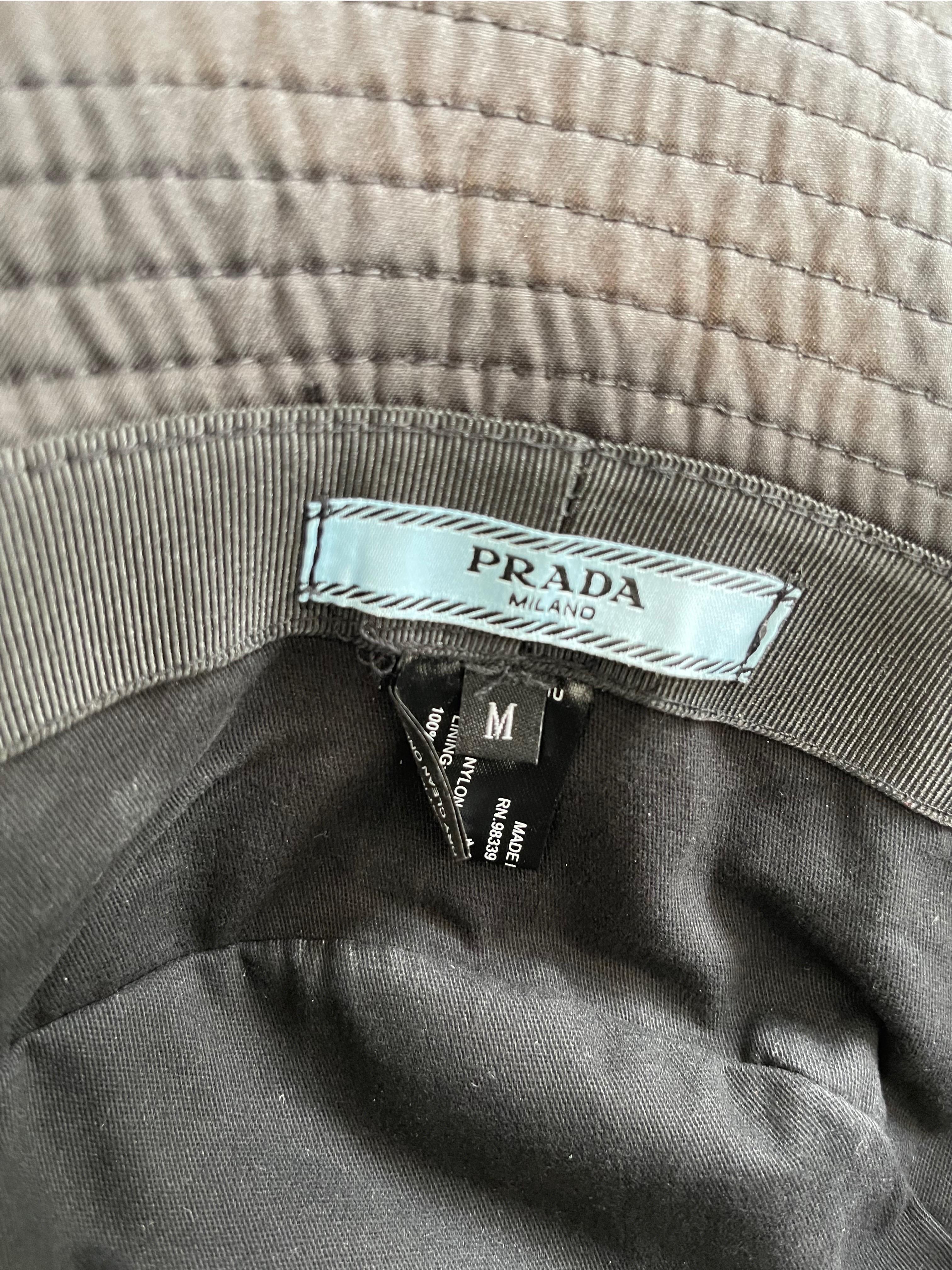 Rare early 2000s black 1990s style PRADA nylon unisex bucket hat ! Logo doesn’t come on the front anymore. Features silver and black upside down triangle logo at center front. 
In great unworn condition
Made in Italy
Marked Size