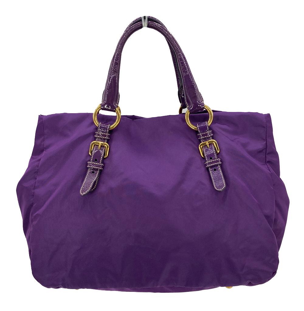 Prada Anemone Tessuto Pietre Nylon Jeweled Tote Bag in good condition. Purple tessuto pietre nylon exterior trimmed with purple patent leather, gold hardware and purple gemstones along the front side. Top snap closure opens to a black nylon interior