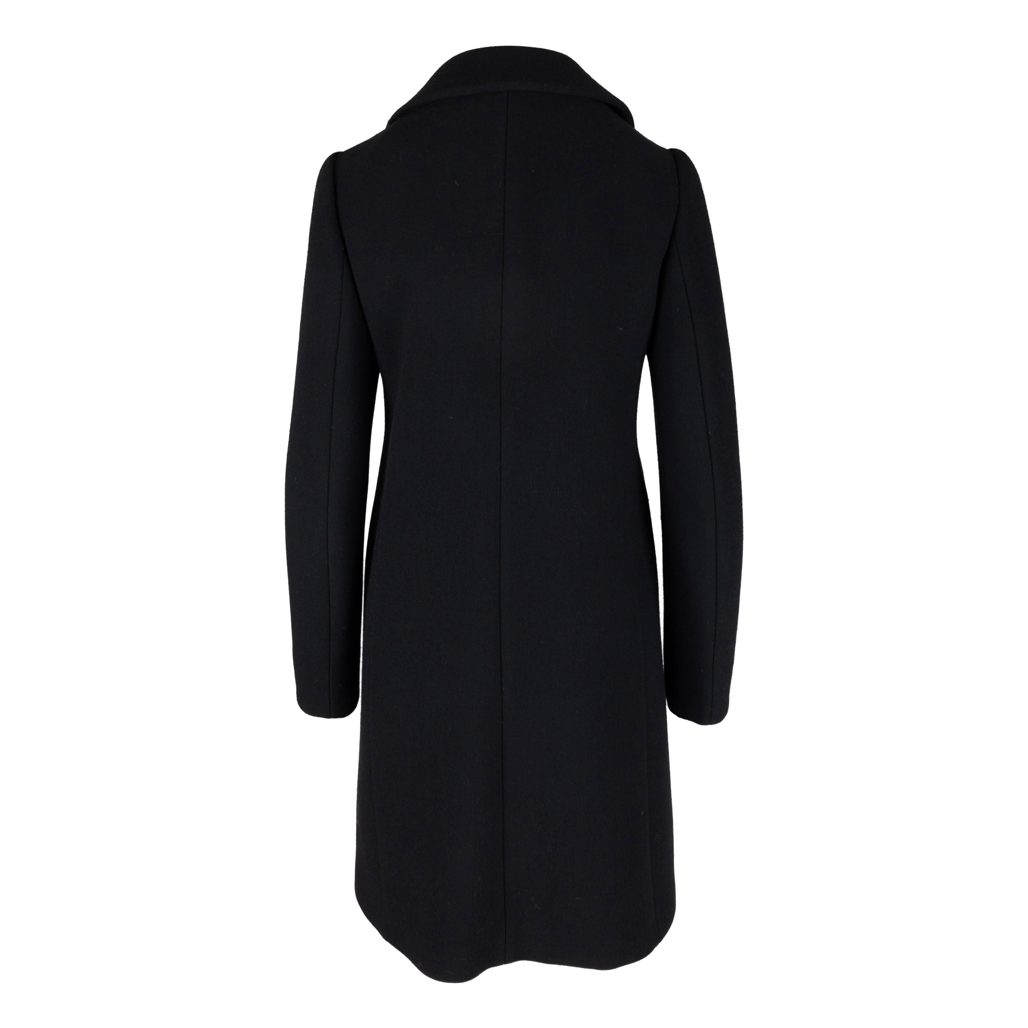 This Prada coat is expertly crafted from virgin wool and is embellished with intricately detailed embroidered appliqués for a truly luxurious finish. Its classic silhouette, collar, and button front closure provide comfort and functionality, while