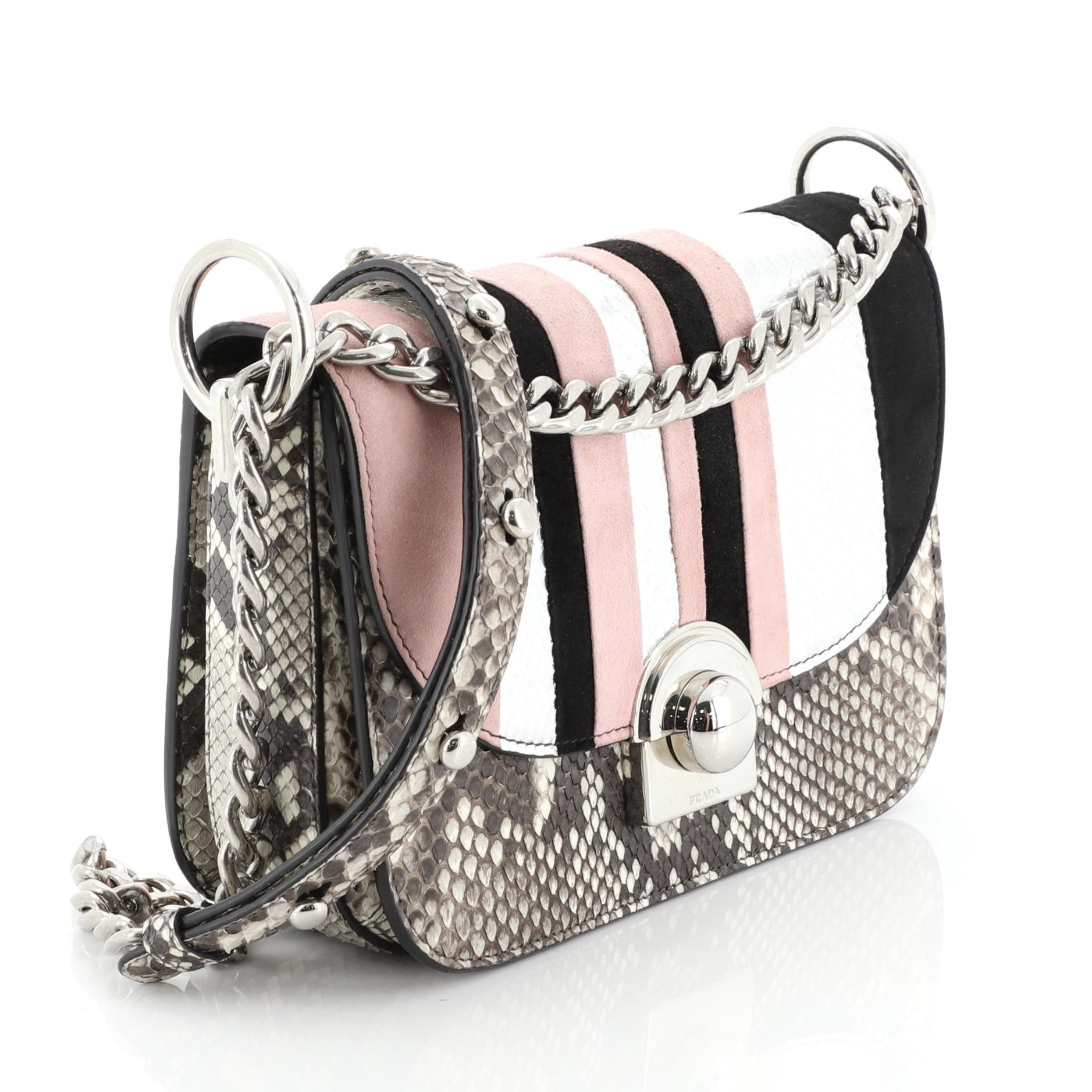 This Prada Arcade Chain Crossbody Python and Suede, crafted from pink and multicolor genuine python and suede, features sliding chain-link strap with shoulder pad and silver-tone hardware. Its snap-lock clasp closure opens to a black leather