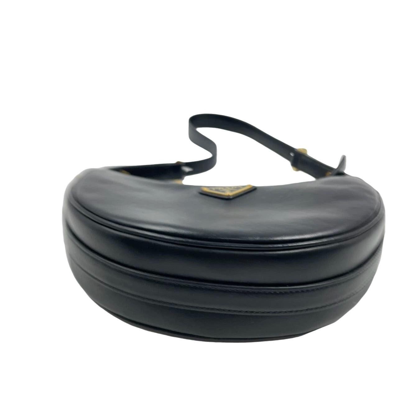 Prada Arqué black calfskin leather shoulder bag Crescent Moon Shape These are professional photos of the actual bag offered by Luxbags. Crafted from high quality black calfskin leather with silver hardware, the Prada Arqué shoulder bag boasts a