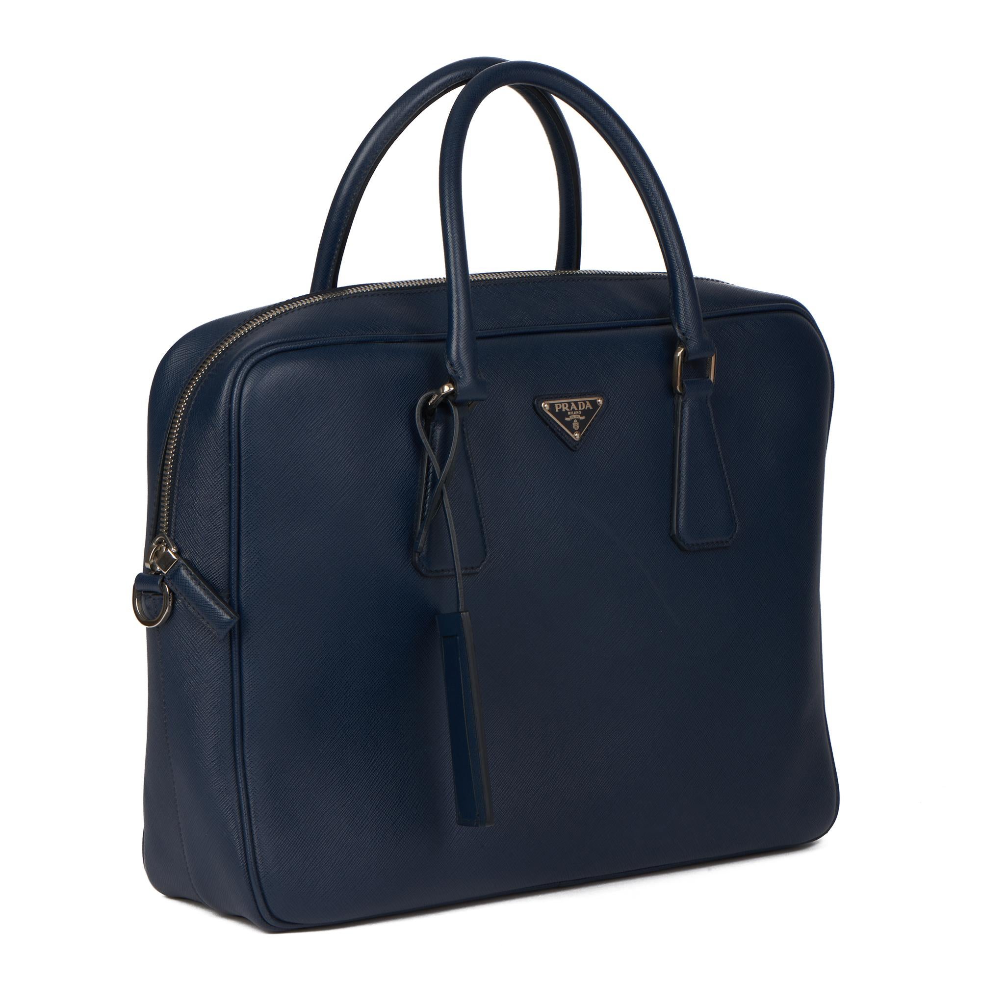 Prada BALTIC BLUE SAFFIANO LEATHER WORK BAG

ONDITION NOTES
The exterior is in excellent condition with light signs of use. There is a scuff front center of the bag.
The interior is in excellent condition with minimal signs of use.
The hardware is