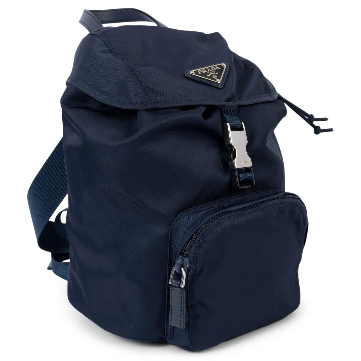 100% authentic Prada Vela backpack bag in navy blue nylon featuring silver-tone hardware. The design comes with two adjustable canvas strap, a zipped front pocket and a drawstring closure und the flap. Lined in navy blue logo canvas with a zipper