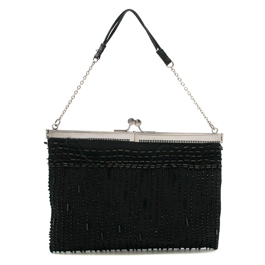 Prada black beaded mini bag.

Fabrics: Silk and Leather.

Please note, these items are pre-owned and may show signs of being stored even when unworn and unused. This is reflected within the significantly reduced price. Please refer to images, and