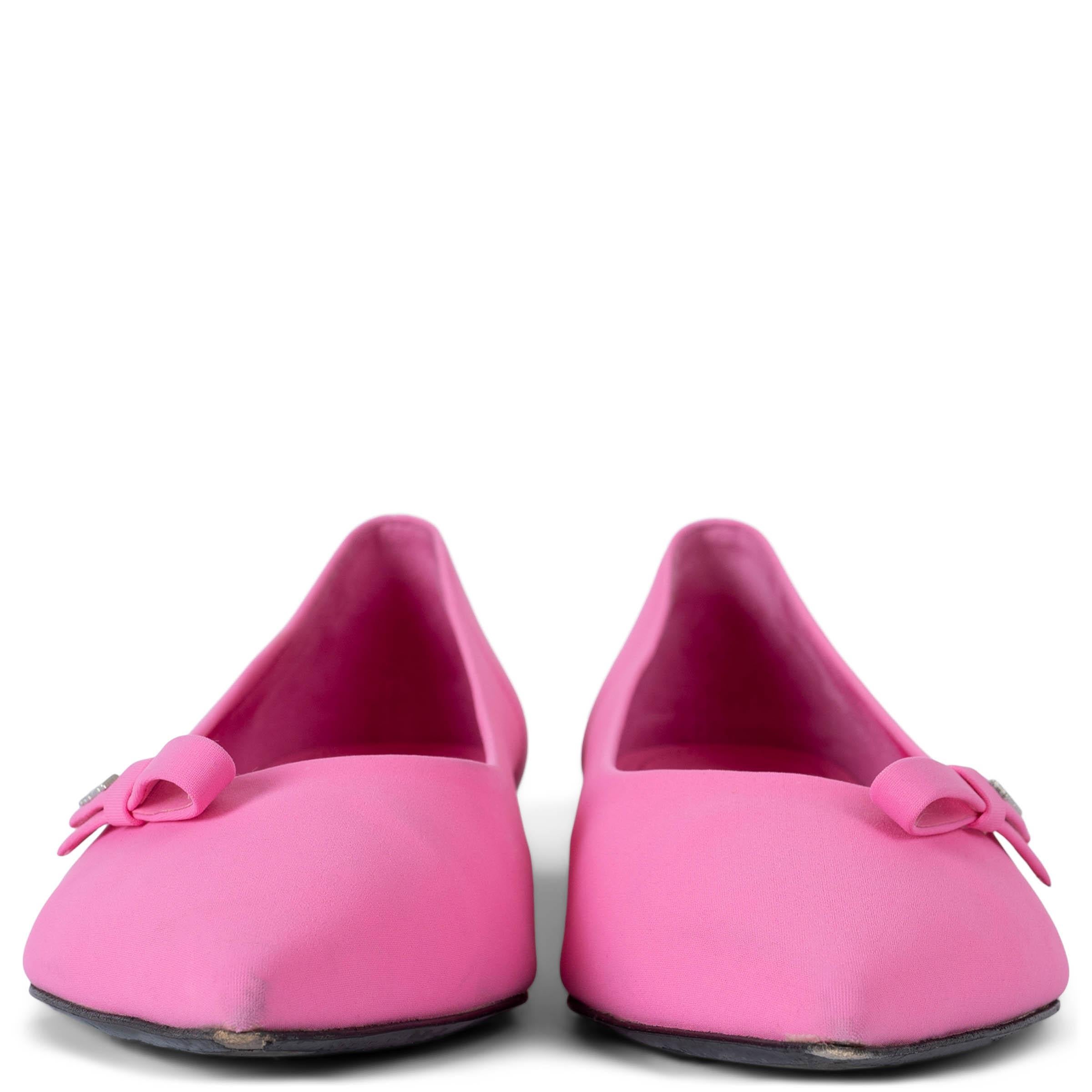 These 100% authentic Prada ballet flats are crafted from bright Begonia pink neoprene, featuring a pointed toe and a metal logo-embellished side bow. Elegant and vibrant, these flats are perfect for adding a bold touch of color to any look. Have