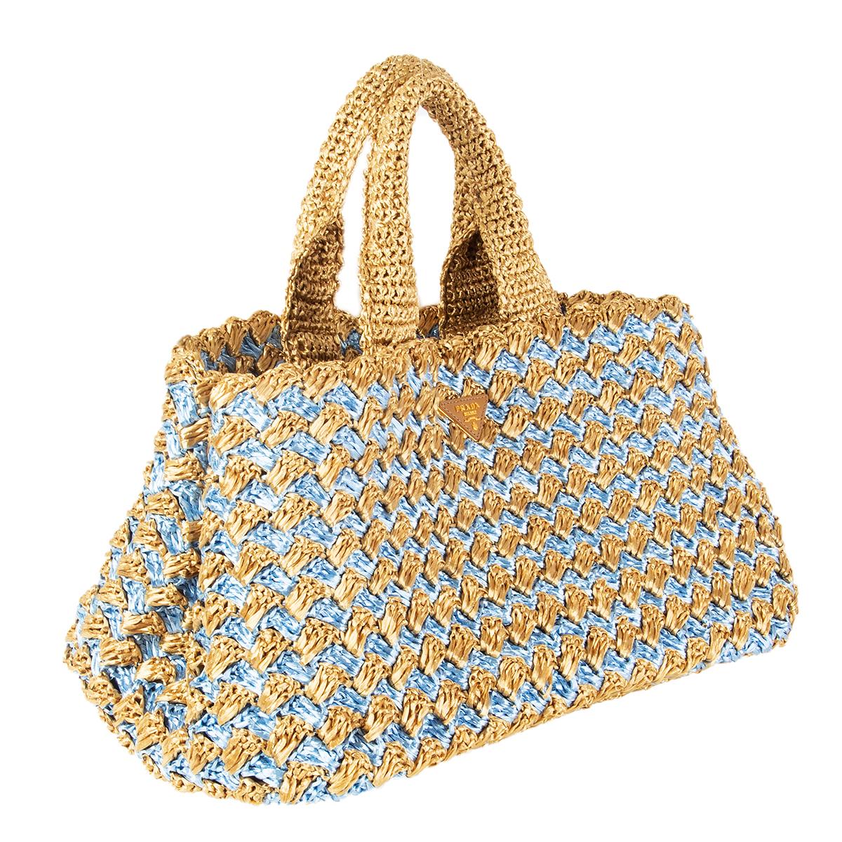 100% authentic Prada 'Canapa' tote in Naturale (beige) and Ciel (baby blue) raffia crochet. Lined in golden-beige nylon with one zip pocket against the back and one against the front with two open pockets attached. Has been carried and is in