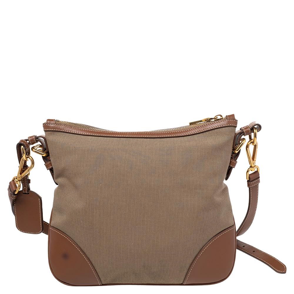 Fall in love almost instantly with this chic bag by Prada. Complement with beige and brown colors, this fashionable bag is all you need to flaunt your trend this season. Get your hands on this striking canvas bag to integral your work-week look.

