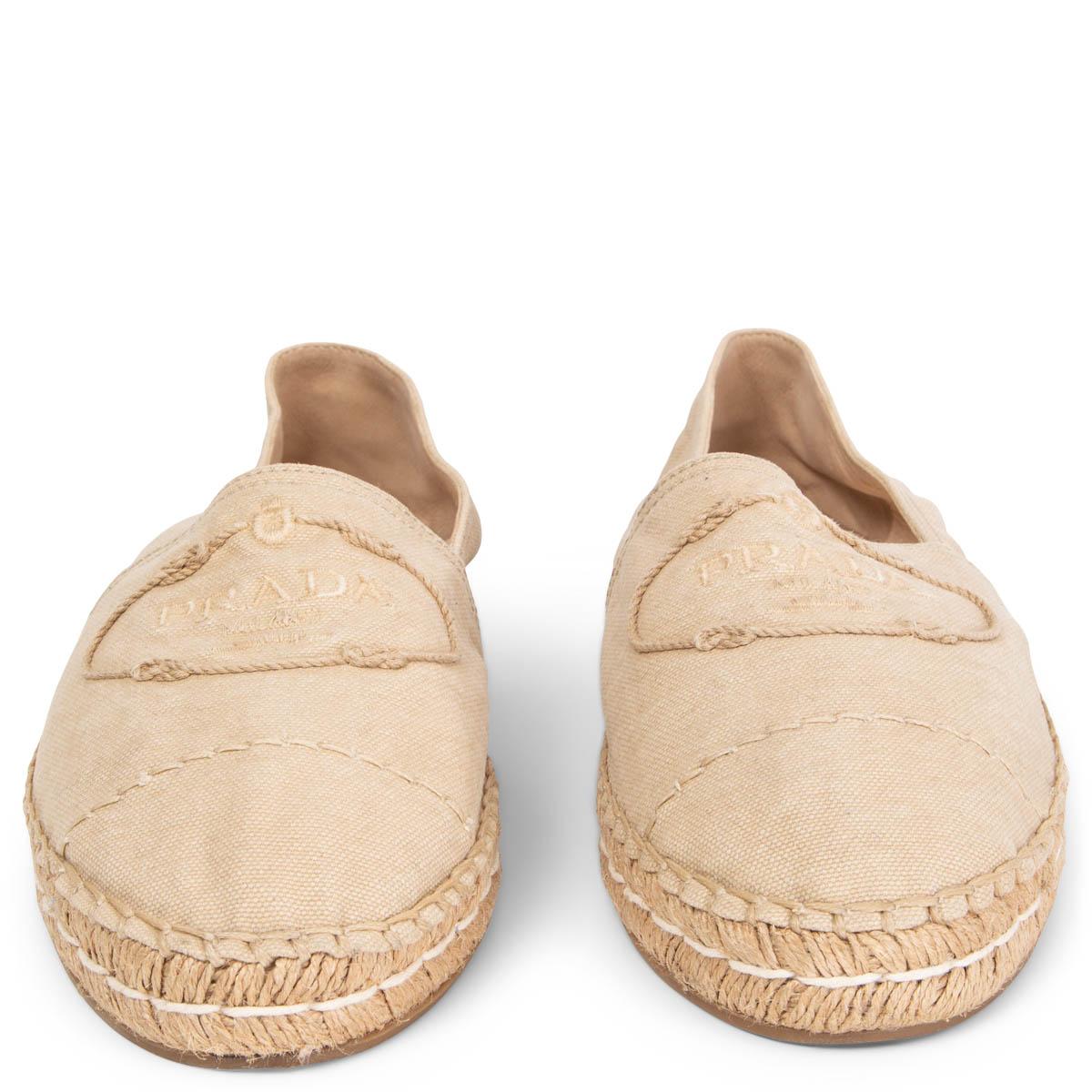 100% authentic Prada Espadrilles made from durable and lightweight light beige cotton canvas that are set upon traditional braided jute soles with the Prada logo, surrounded by knotted stitching. Have been worn once or twice and are in excellent