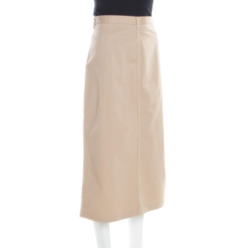 This midi skirt from Prada is chic, stylish and very sophisticated! The beige creation is made of a cotton blend and features a contrasting stitch detailing. It flaunts belt loops and comes equipped with a concealed zip closure at the back. Pair it