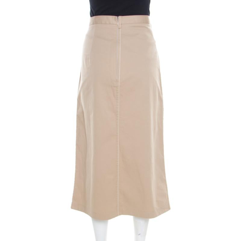 This midi skirt from Prada is chic, stylish and very sophisticated! The beige creation is made of a cotton blend and features a contrasting stitch detailing. It flaunts belt loops and comes equipped with a concealed zip closure at the back. Pair it