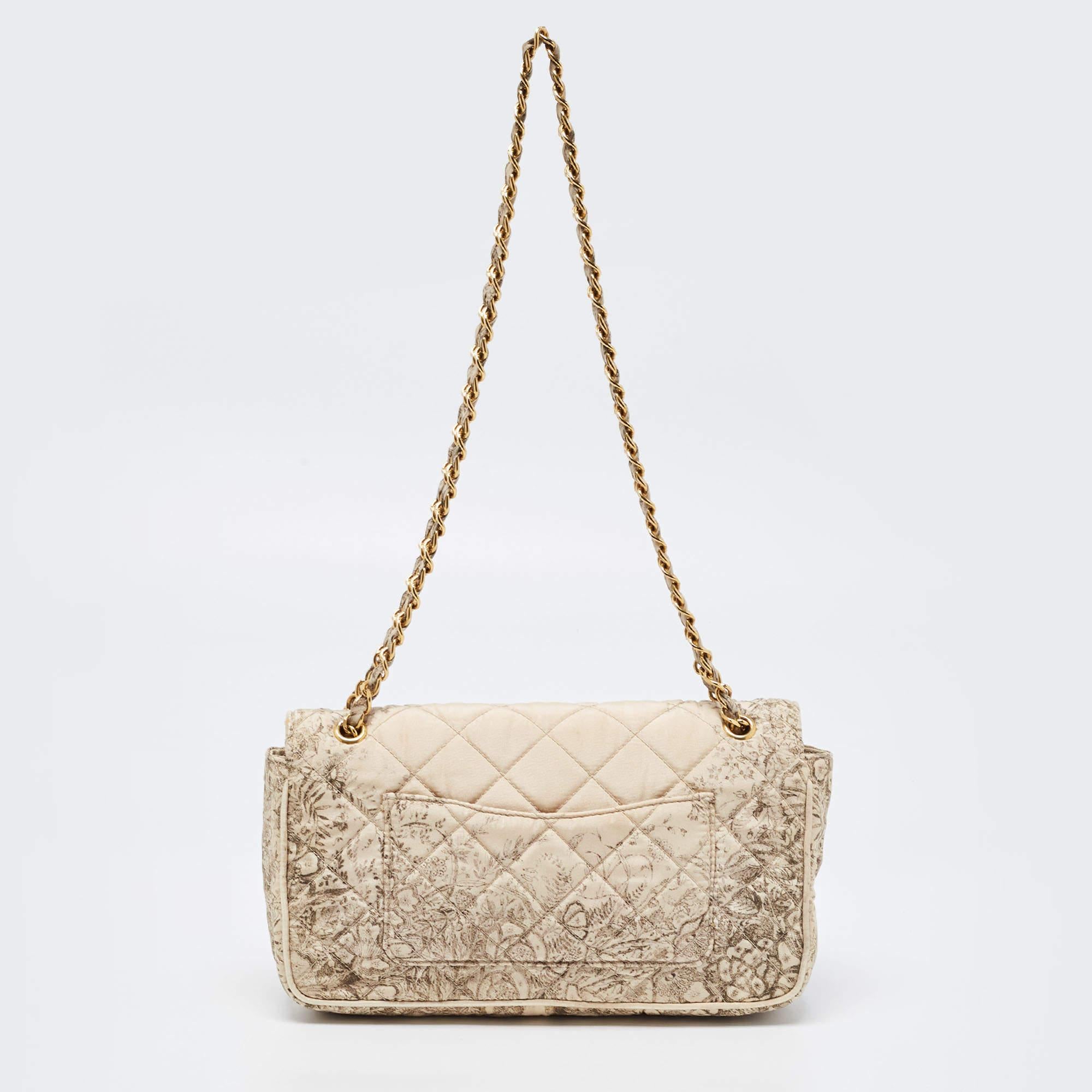 If you are looking for a bag with a blend of modern style and class, this Prada creation is the answer. Crafted from quilted satin, this beige piece comes with a chain link and a flap to secure the well-sized interior. It will surely make a prized