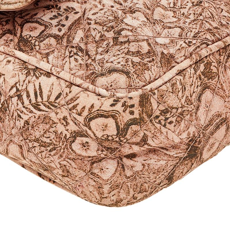 Experience fine craftsmanship with this immaculately designed bag by Prada. It has a floral-print quilted silk exterior, a woven shoulder handle, flap closure, and a nylon-lined interior.

Includes: Authenticity Card, Info Booklet