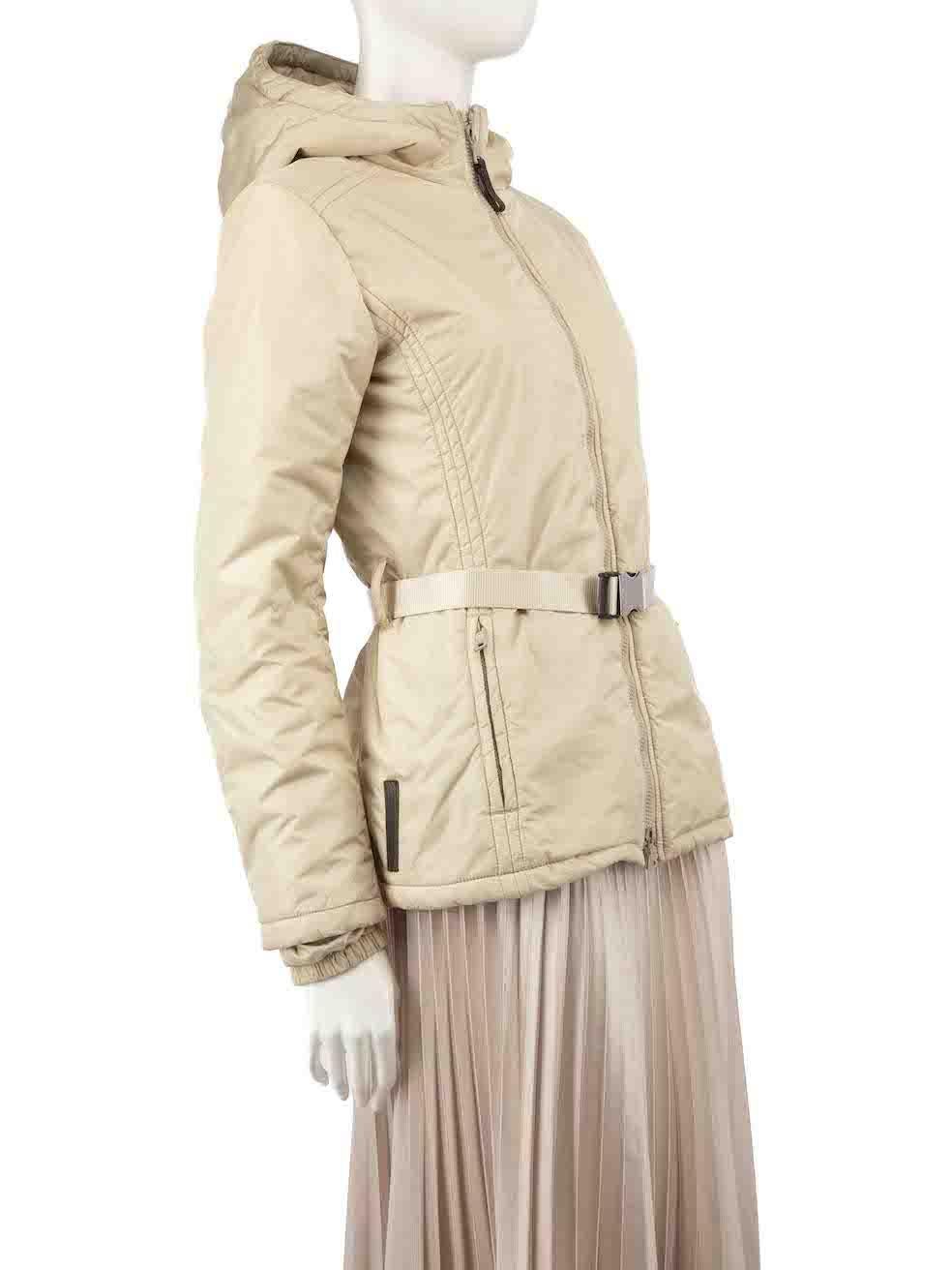 CONDITION is Very good. Minimal wear to coat is evident. Minimal wear to metal belt buckle, with some scratches and tarnishing to the pocket zip pullers on this used Prada designer resale item.
 
 
 
 Details
 
 
 Beige
 
 Synthetic
 
 Shell jacket
