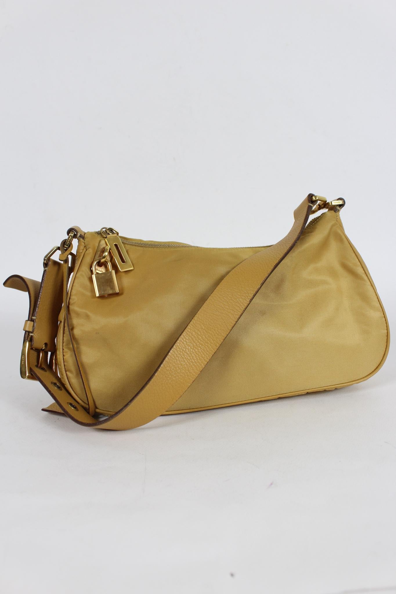 Prada Hobo vintage shoulder bagS 2001s. Honey color with gold-colored details. Zip and padlock closure with key, internal zip pocket. Adjustable shoulder strap. The composition is in nylon and deerskin. The dustbag is present. Made in