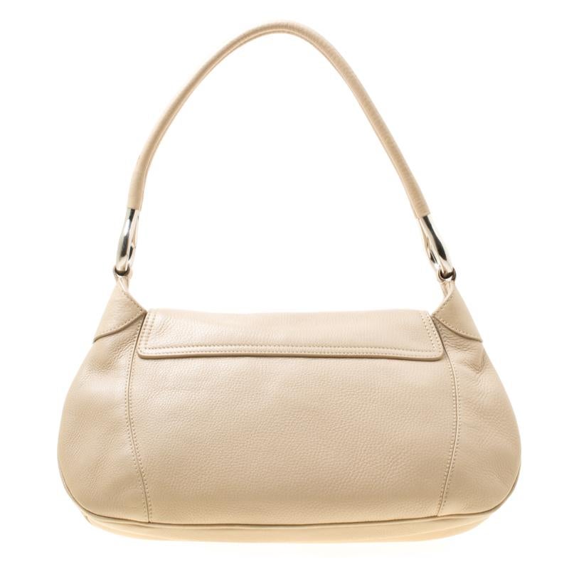 This beige bag from Prada will easily go with all your dresses. Crafted from leather the bag features a top handle and a front flap. The nylon lined interior will hold all your essentials with ease.

