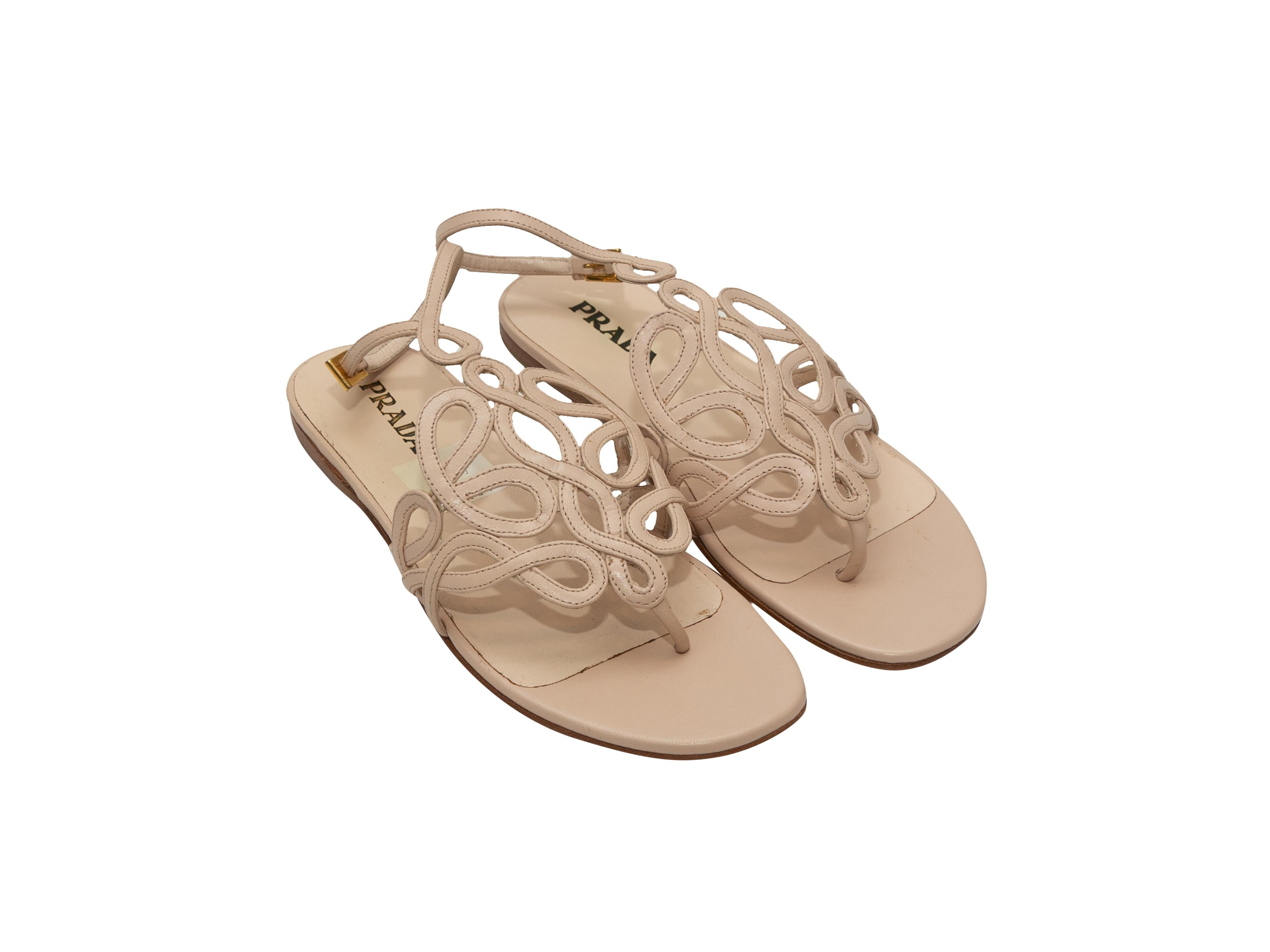 Product details: Beige leather flat thong sandals by Prada. Gold-tone buckle closures at ankle straps. Designer size 36.5.
Condition: Pre-owned. Excellent.