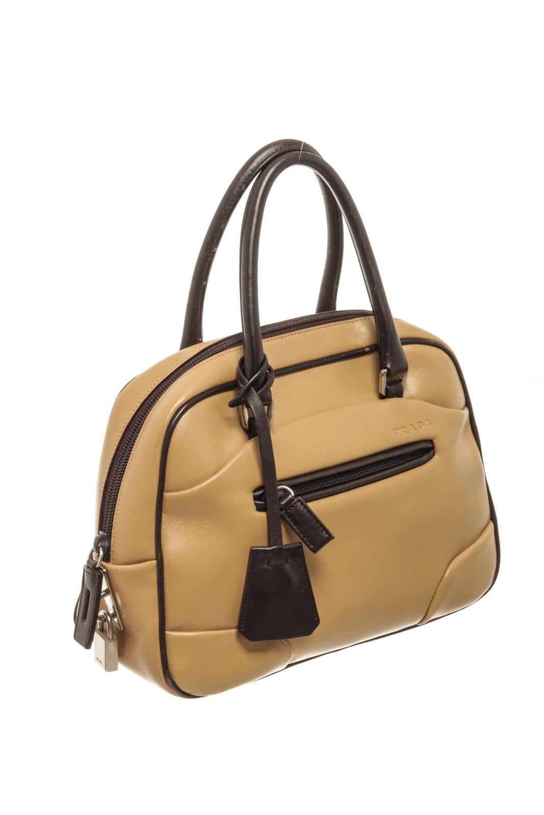 Prada Beige Leather Tote Bag with tonal hardware rolled handles, single exterior zipper pocket, logo jacquard lining & single interior pocket zip closure at top, Prada fabric lining. 

80703MSC