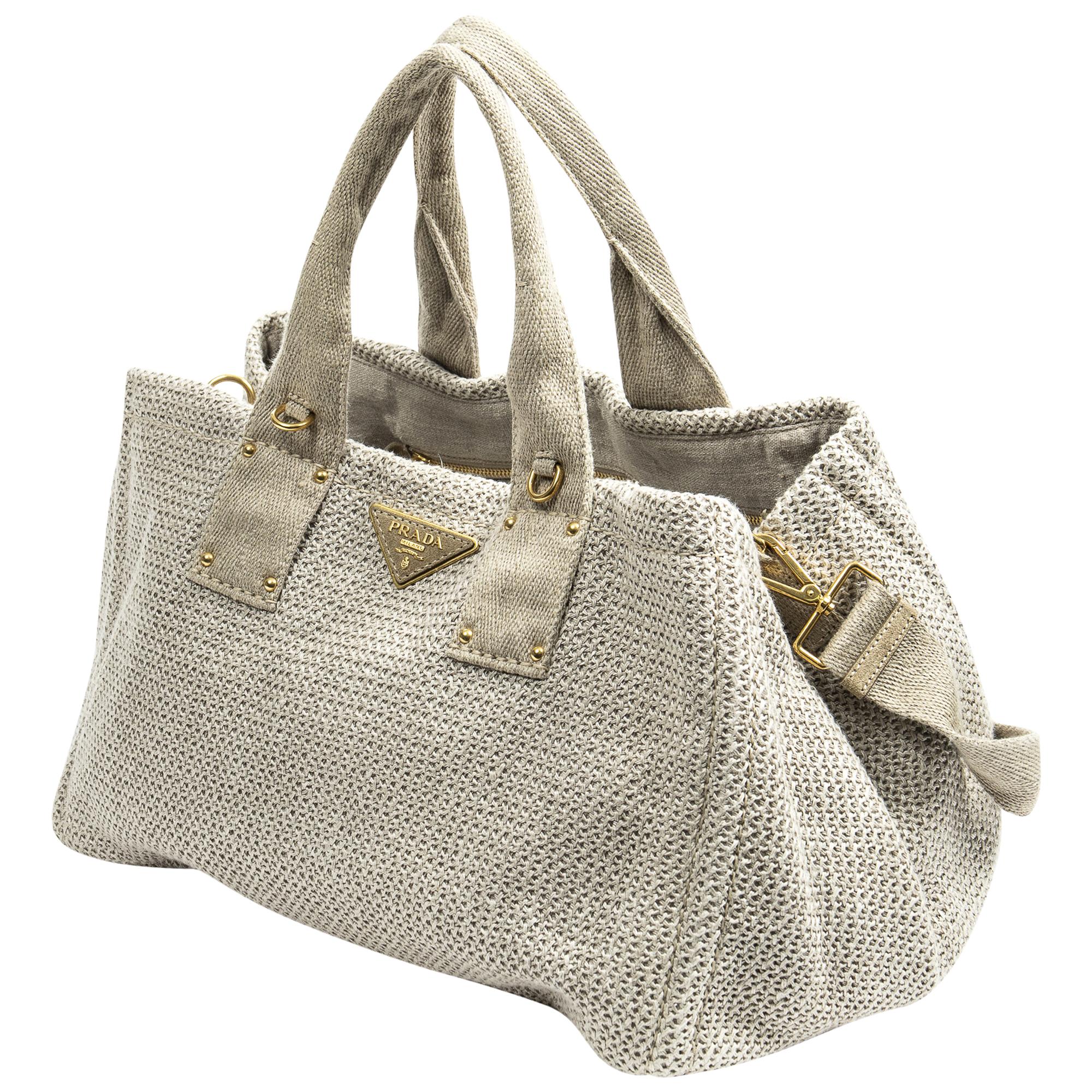 Elevate your everyday ensemble with the Prada Beige Medium Woven Canapa Tote. Crafted from durable canvas in a timeless beige hue, it exudes understated sophistication. Adorned with gold-tone hardware and featuring an open-top design, its spacious