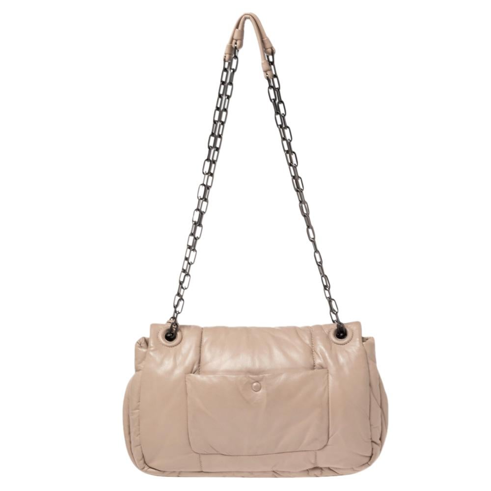 Trade that everyday tote with this charming shoulder bag from the house of Prada. It features a bomber leather body, chain link straps, and a black-tone lock on the front. The well-sized interior can hold your daily essentials with great