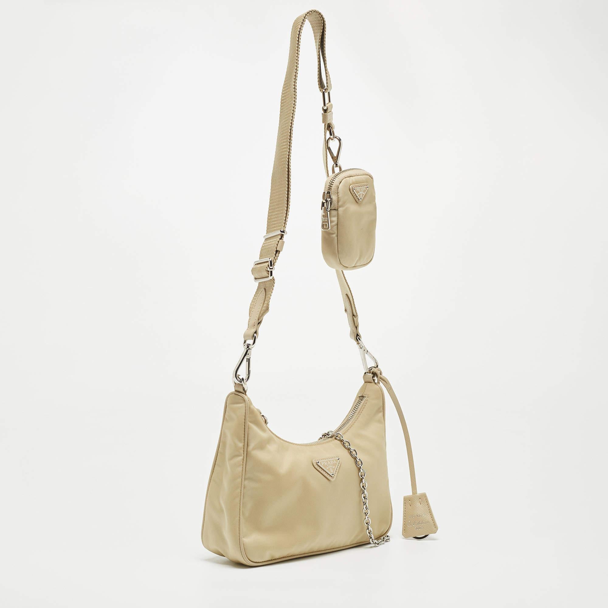 The petite silhouette and classic elements made the Prada Re-Edition 2005 bag an instant hit among fashionistas. Inspired by the classic mini hobo bag, this beige creation comes made from nylon and features a single handle at the top. The perfectly