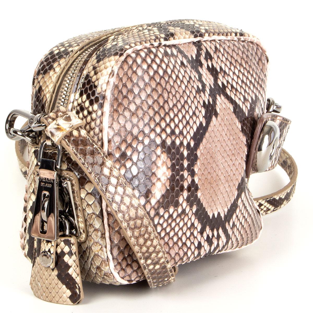 Prada crossbody bag in Cipria/Rocci (beige-taupe, rose-taupe and espresso brown) python from the Fall 2011 runway. Opens with a zipper on top and is lined in nude soft lambskin with two open pockets. Has a detachable and adjustable shoulder strap