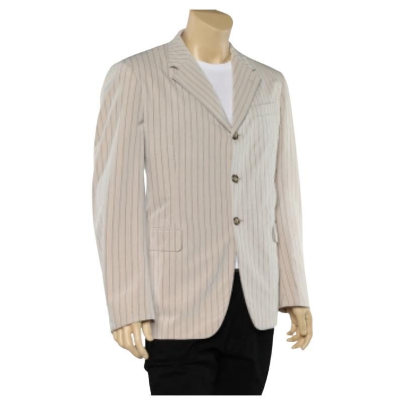 This beige blazer from Prada will make for a nice addition to your luxurious collection. It is stitched skillfully from cotton and has front buttons. The pinstriped blazer will match well with trousers and statement shoes.