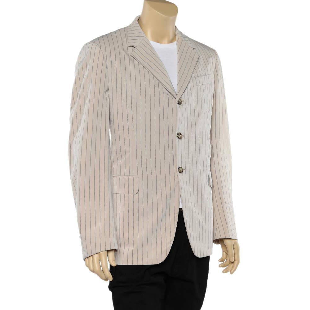 This beige blazer from Prada will make for a nice addition to your luxurious collection. It is stitched skillfully from cotton and has front buttons. The pinstriped blazer will match well with trousers and statement shoes.

