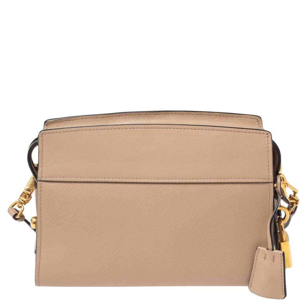 This Esplanade bag by Prada will be a fine companion to a woman who is heading to work or brunch. This chic bag is brilliantly fashioned and spaciously sized. The Saffiano leather used for the bag assures durability while the brand name on the front
