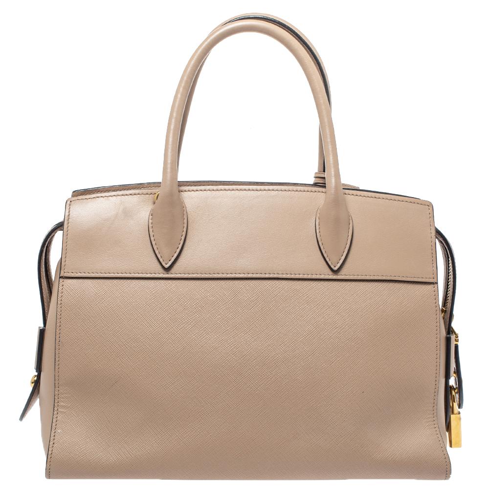 This bag by Prada is a lovely companion for a fashionable woman. This leather bag is brilliantly fashioned and spaciously sized. The Saffiano leather used in this bag assures long durability while the brand name on the front adds a signature