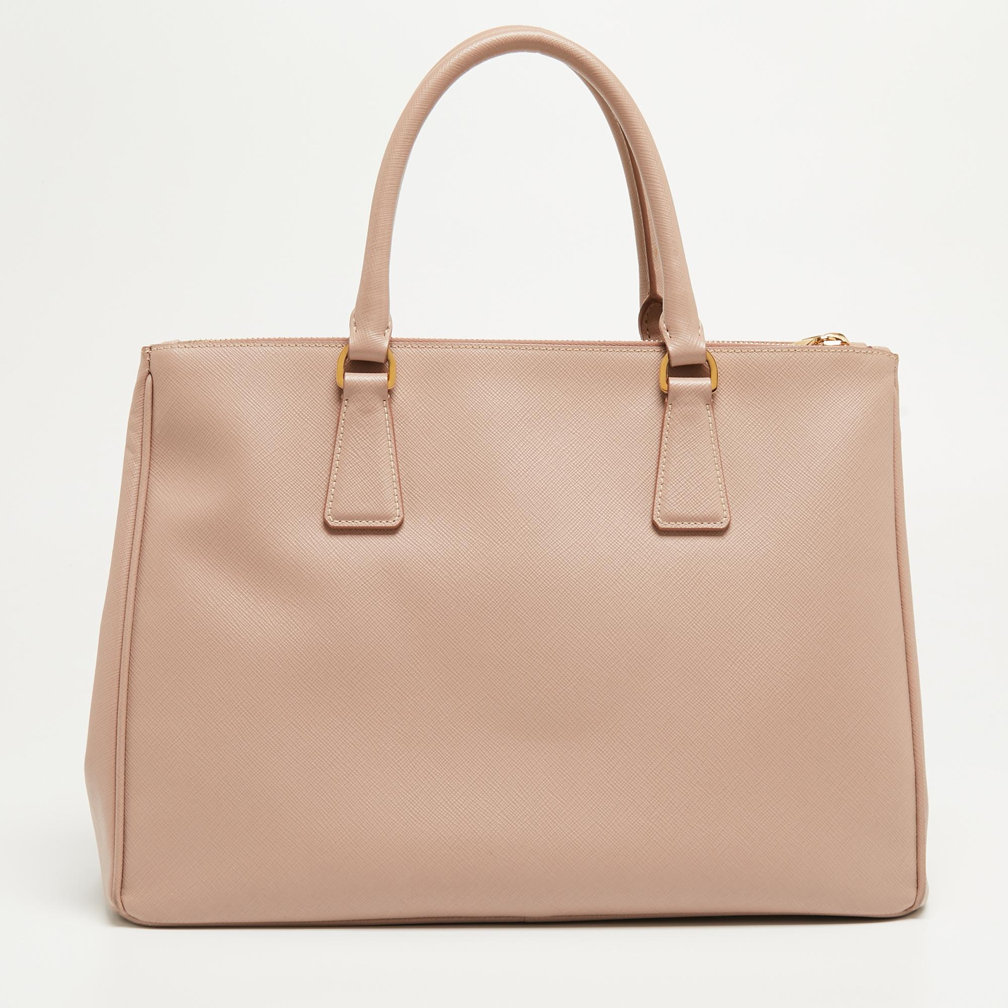 This alluring tote bag for women has been designed to assist you on any day. Convenient to carry and fashionably designed, the Prada tote is cut with skill and sewn into a great shape. It is well-equipped to be a reliable accessory.

Includes: