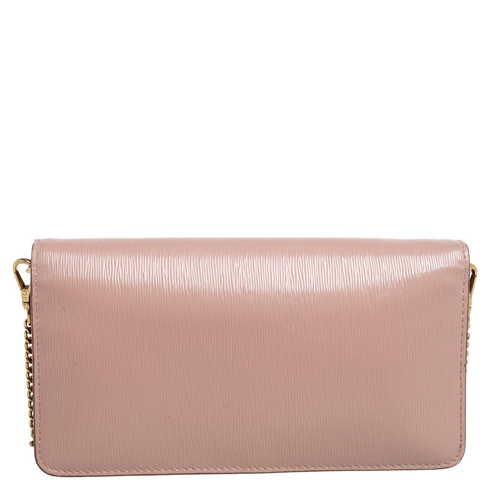 Crafted in Italy, this Prada WOC is made from Vitello Move leather and comes in pink. It has a front flap with the signature detail and it opens to a lined interior. The bag is equipped with a shoulder chain in gold-tone.

Includes: Authenticity Card
