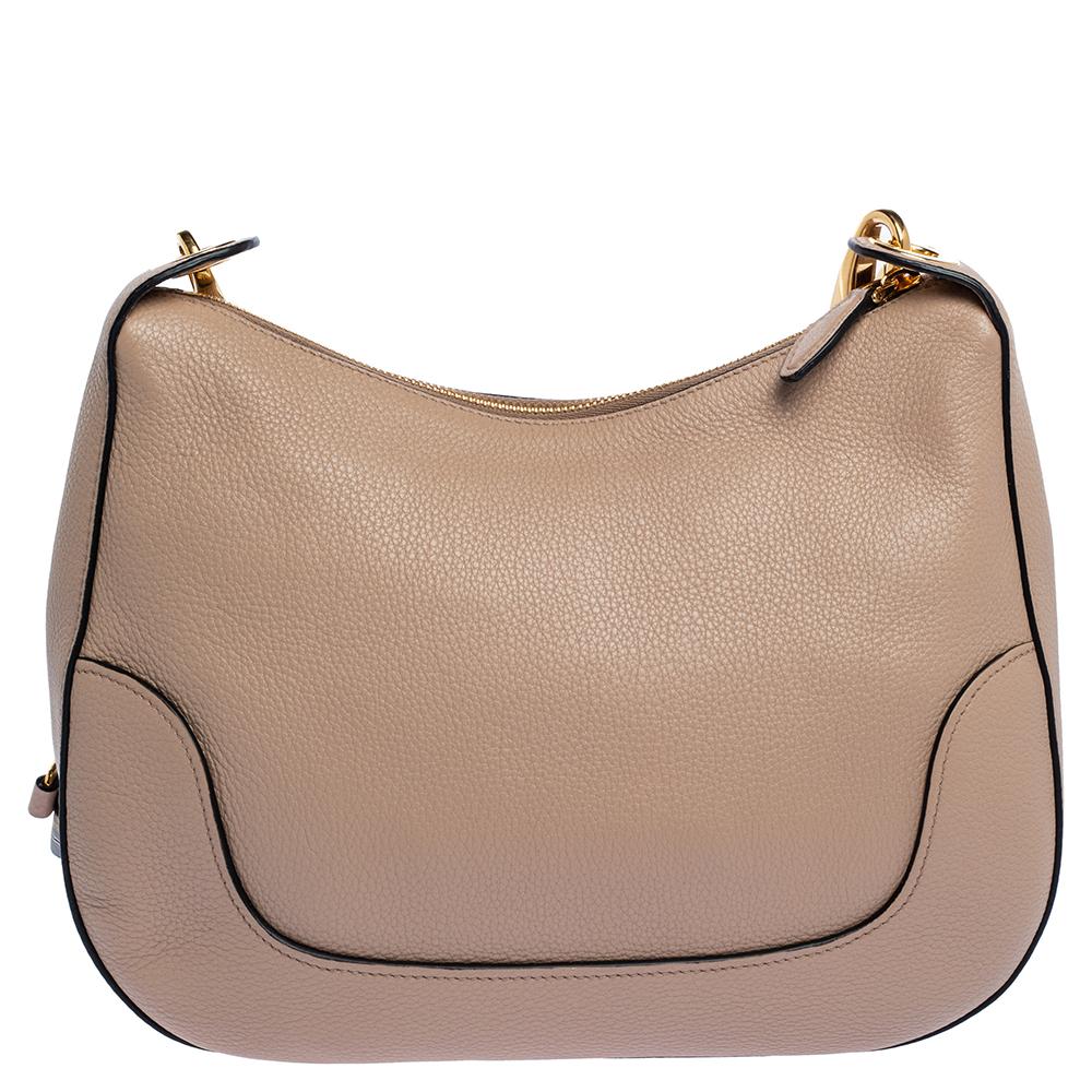 This Prada Phenix tote is an example of the brand's magnificent designs fused strikingly with the current fashion trends. Showcasing timeless craftsmanship, it is made from beige Vitello leather, is lined with nylon, and features gold-tone hardware.