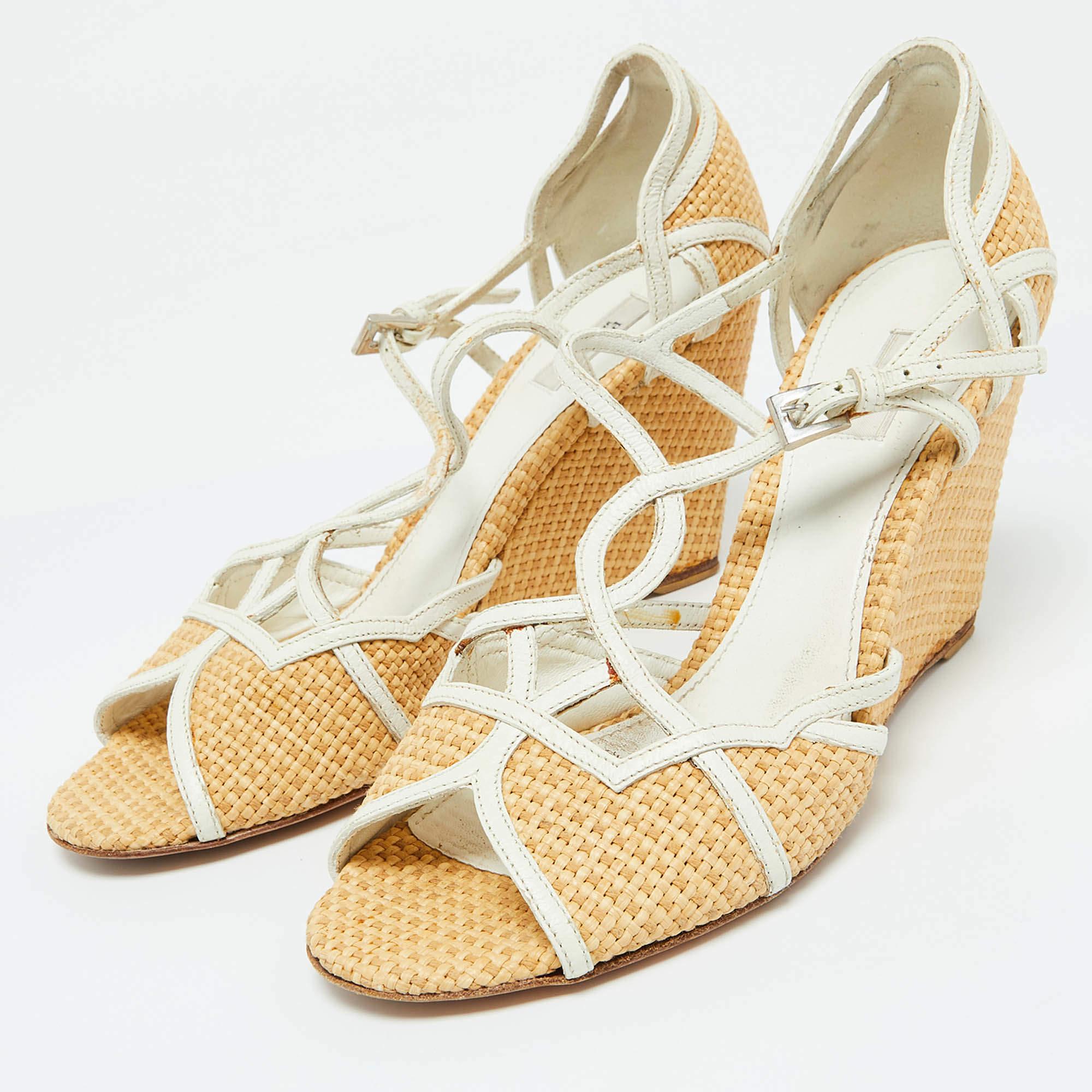 Pradas wedge sandals will be a go to pair as theyre perfect to wear for long hours with flowy dresses to tailored co ord sets. The shoes have woven leather upper matched and complemented beautifully by a wicker platform wedge heel thus creating a