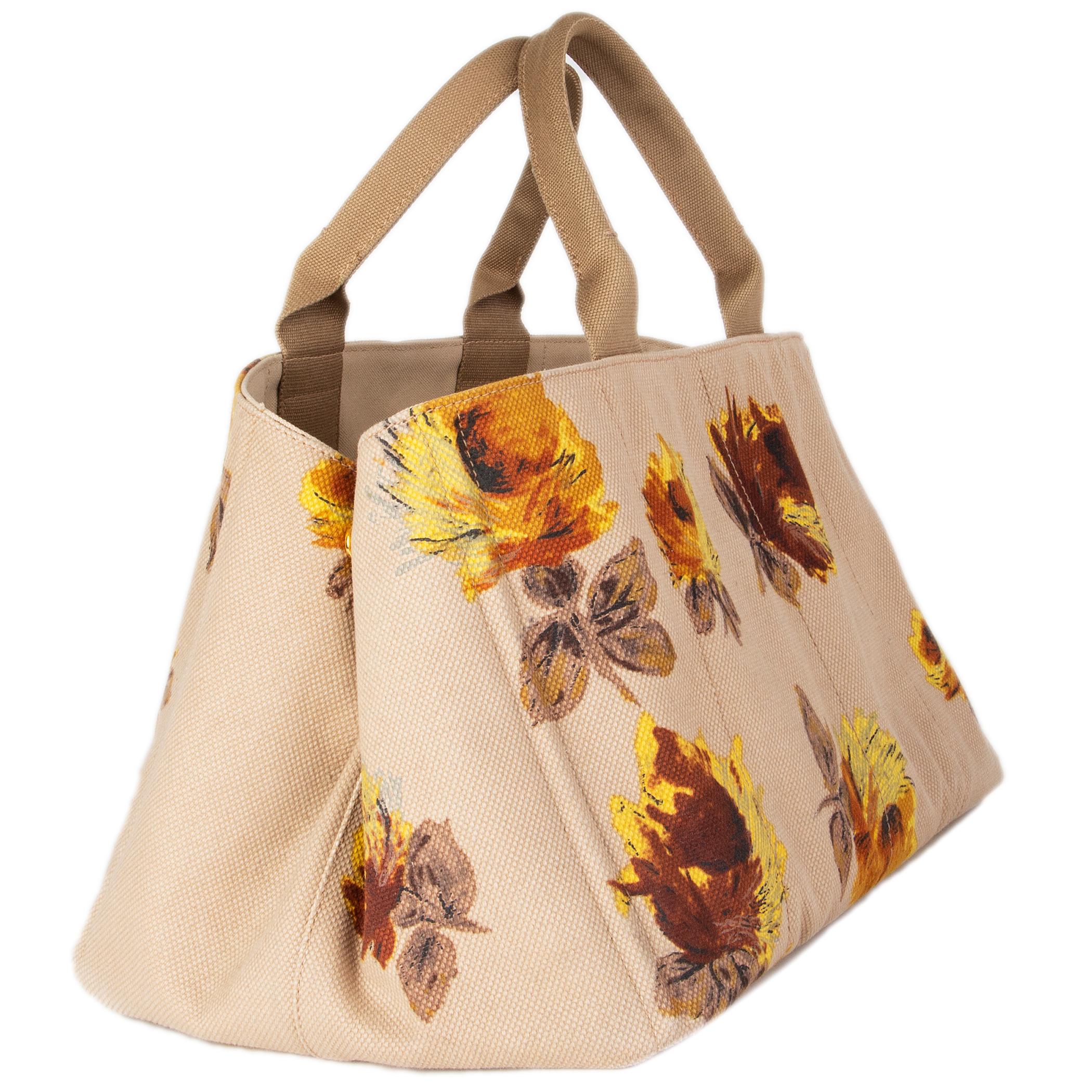 Prada 'Canapa Large' tote in beige canvas with rust brown and yellow floral-print. Lined in beige canvas with a zipper pocket against the front and a zipper and open pocket against the back. Has been carried and is in excellent condition.

Height