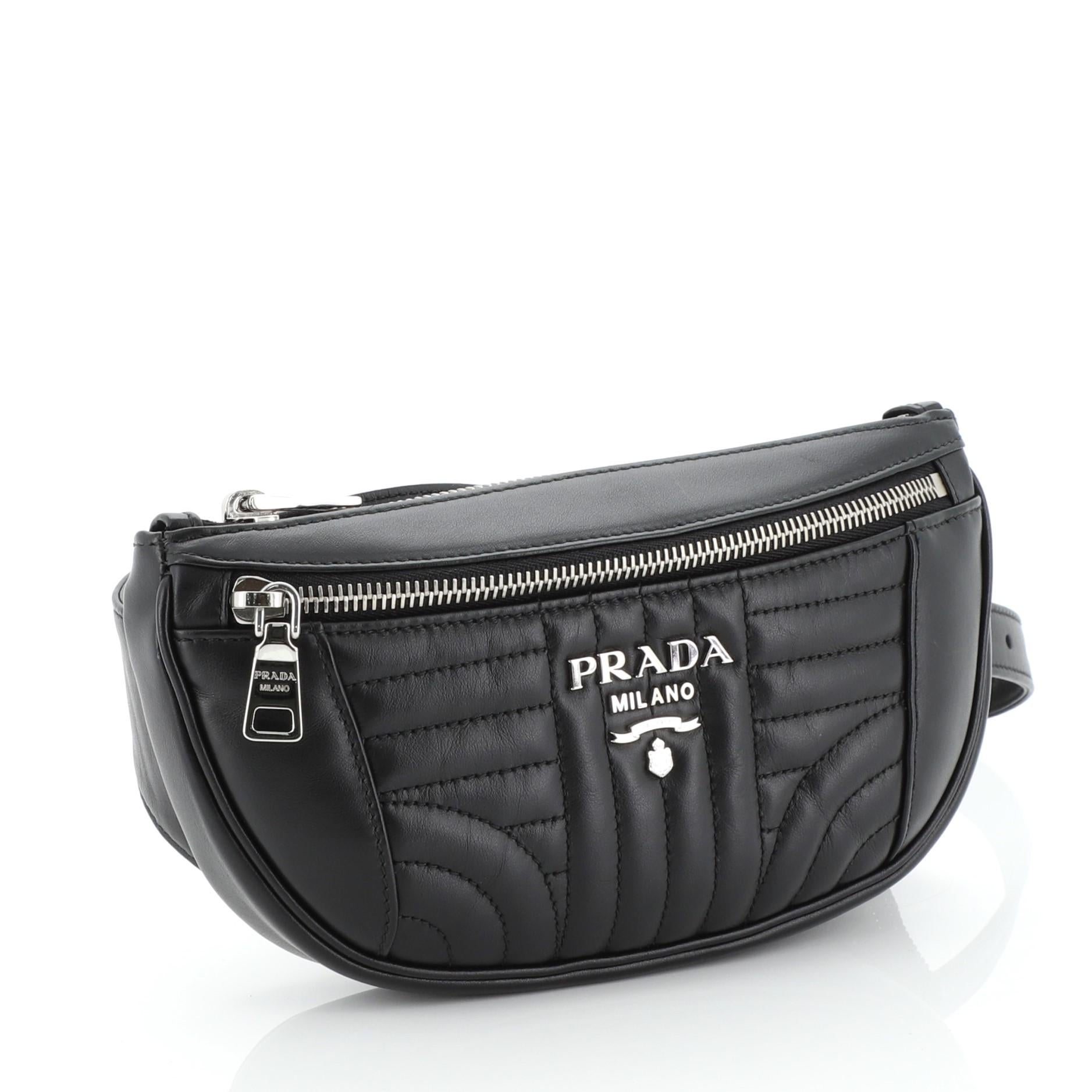 This Prada Belt Bag Diagramme Quilted Leather Small, crafted in black diagramme quilted leather, features an adjustable belt strap, exterior zip pocket and silver-tone hardware. Its zip closure opens to a black fabric interior. 

Estimated Retail