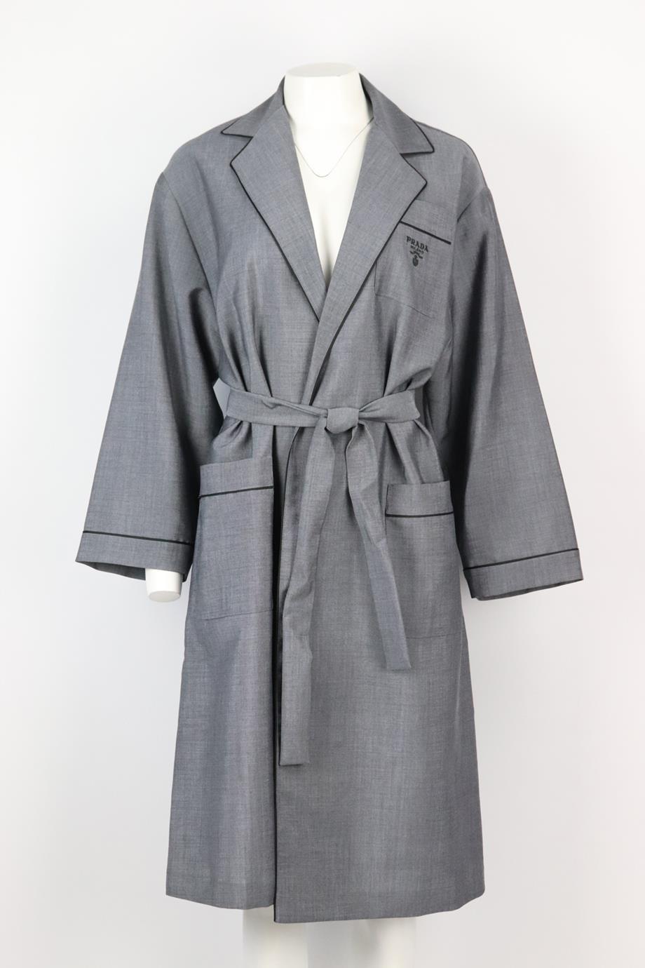 Prada belted logo embroidered wool blend robe. Grey. Long sleeve, v-neck. Belt fastening at front. 60% Mohair, 40% wool; lining: 100% viscose. Size: XSmall (UK 6, US 2, FR 34, IT 38). Shoulder to shoulder: 19.5 in. Bust: 44 in. Waist: 43 in. Hips: