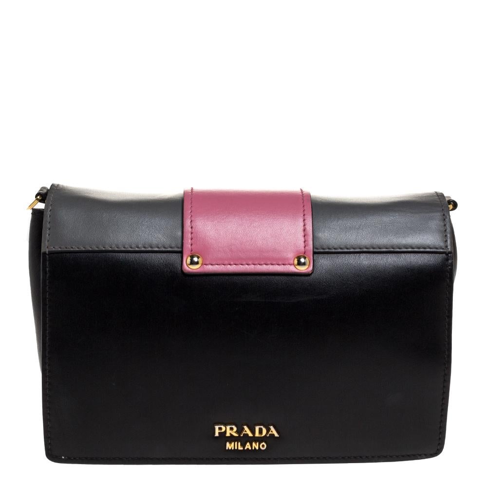 High on style, carry this bag from Prada without compromising on style. Look stunning with this multicolor bag crafted from quality leather. It has a front flap with ribbon-like detailing and brand logo. It opens to a spacious nylon-lined interior