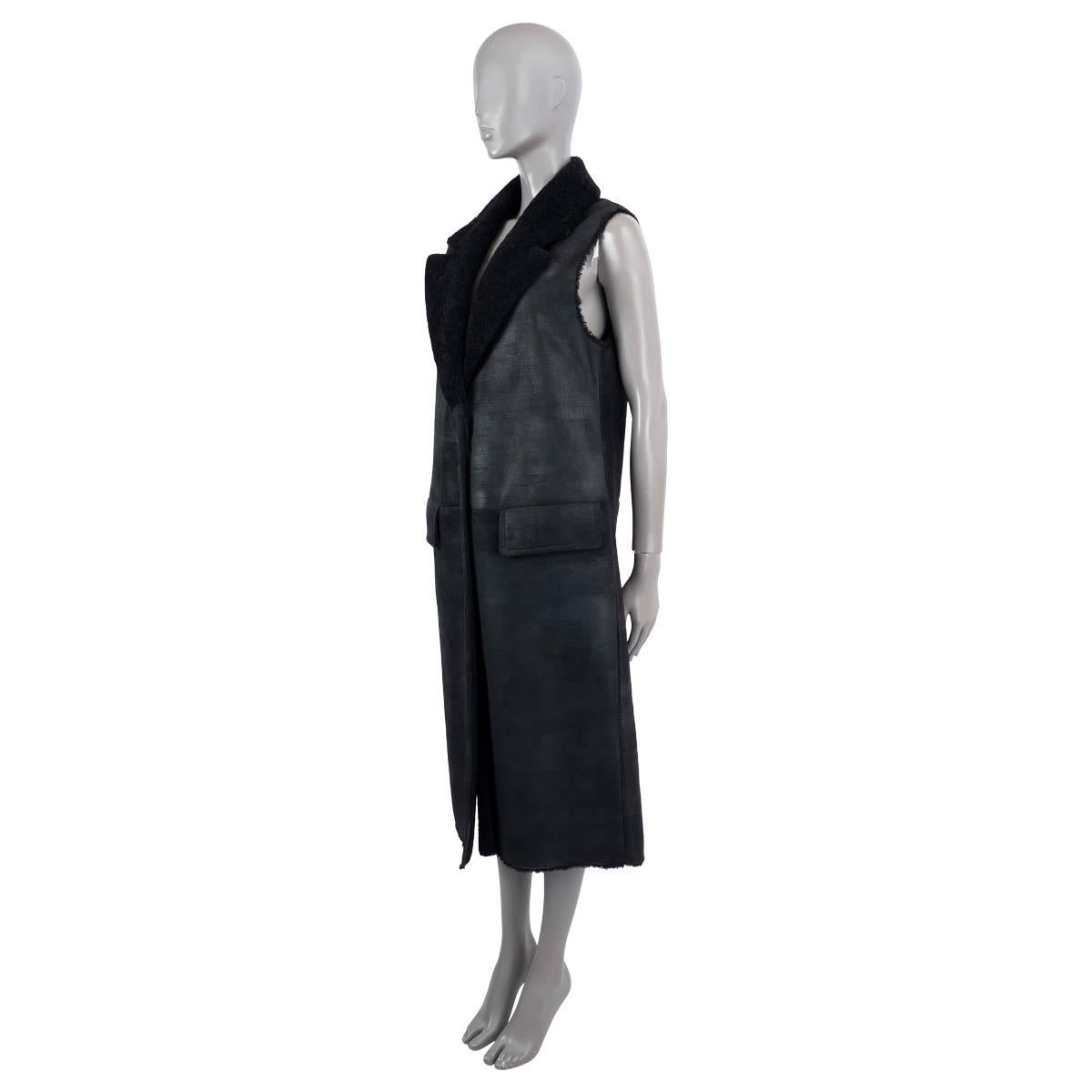 100% authentic Prada 2020 midi-length vest in black shearling with distressed surface. Opens with three buttons on the front, has two front flap pockets and a slit on the back. Has been worn once and is in virtually new condition. 

Measurements
Tag