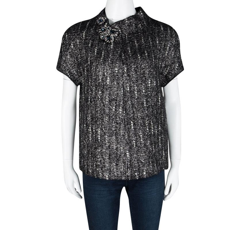 You'll love this short sleeve top from Prada for its delightful style. In a lovely grey and black textured design, this top is made of wool and features a sophisticated design with a high neck embellished with stones and crystals.

Includes: The