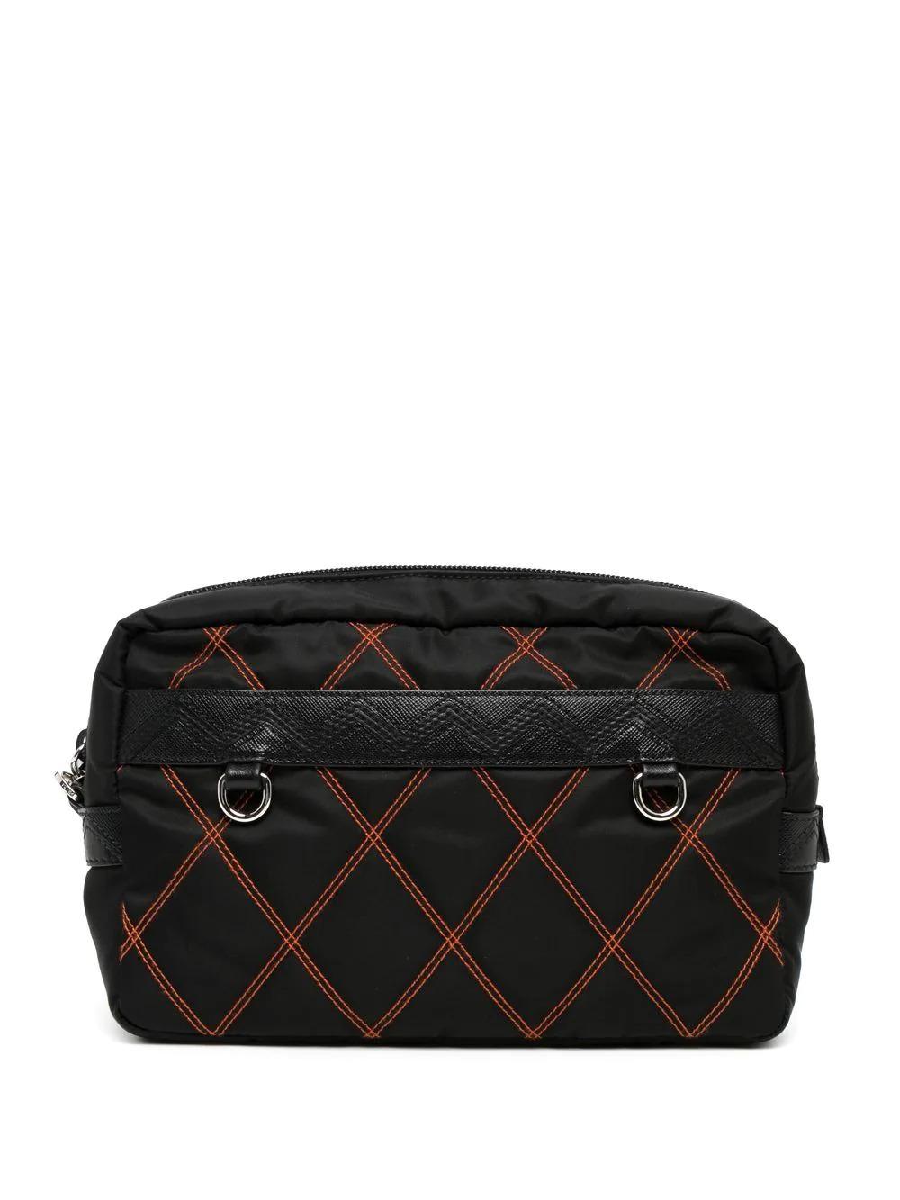 Perfectly sized to fit your makeup collection or for weekends away. This pre-owned Prada cosmetic pouch has been designed from black nylon and features an orange quilted stitch design and black Saffiano leather trim. Designed with a zip pocket, you