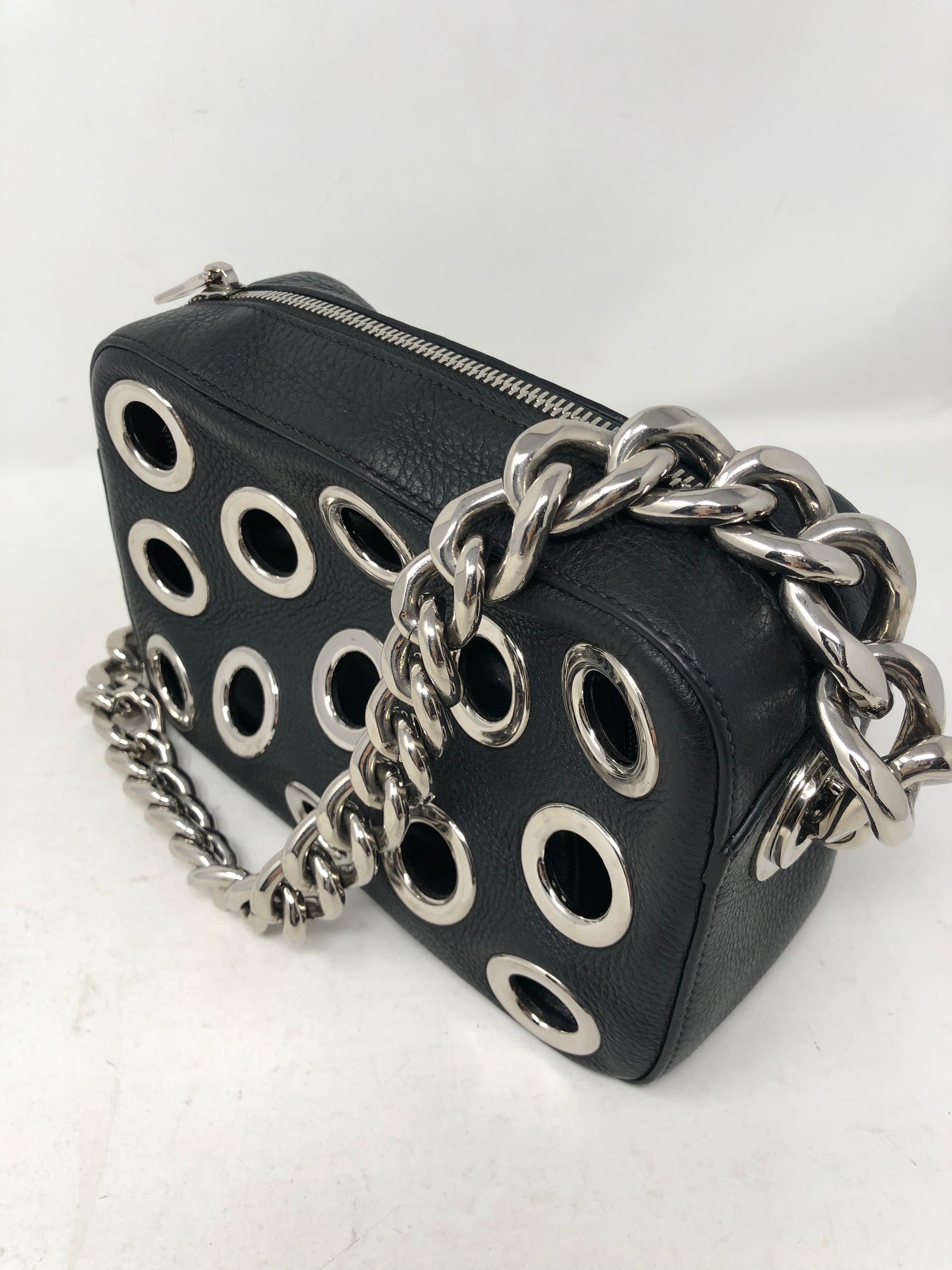 Prada Black Art Bag with Silver metal holes. Silver hardware. Unique style and wearable art. Leather interior with extra leather pouch included. Mint condition. Guaranteed authentic. 